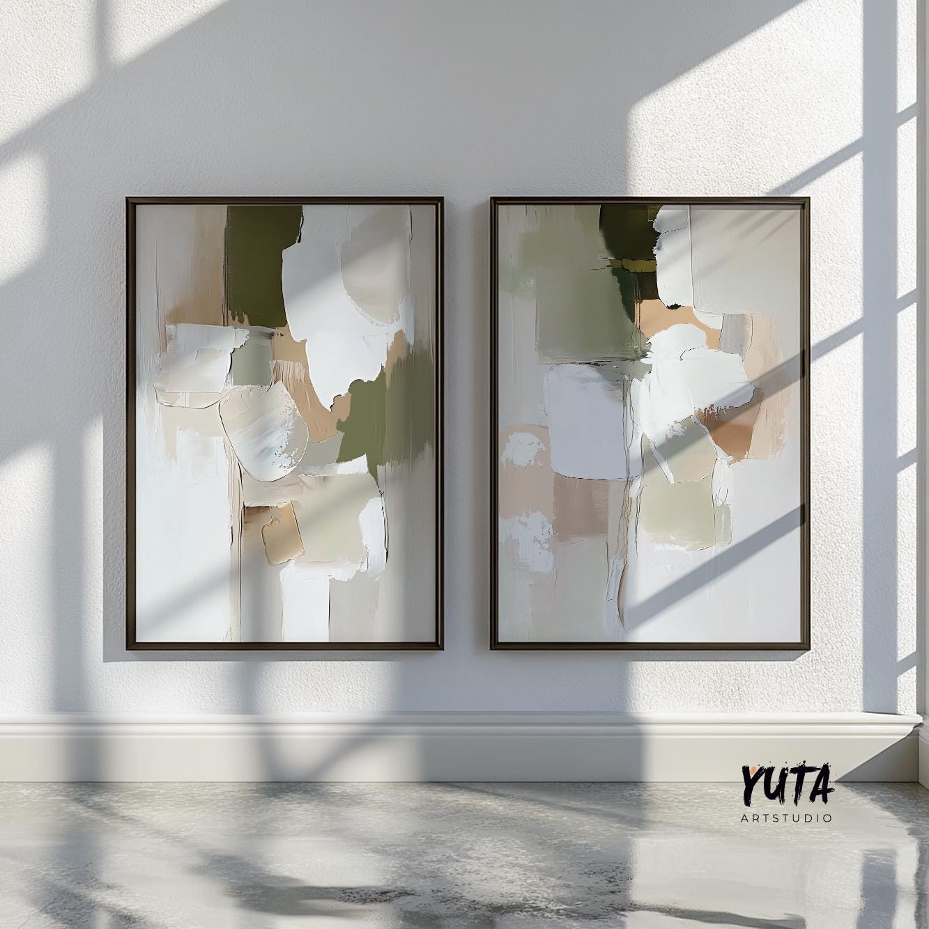 Abstract pastel olive and beige brushstroke prints in dark frames on a sunlit white wall