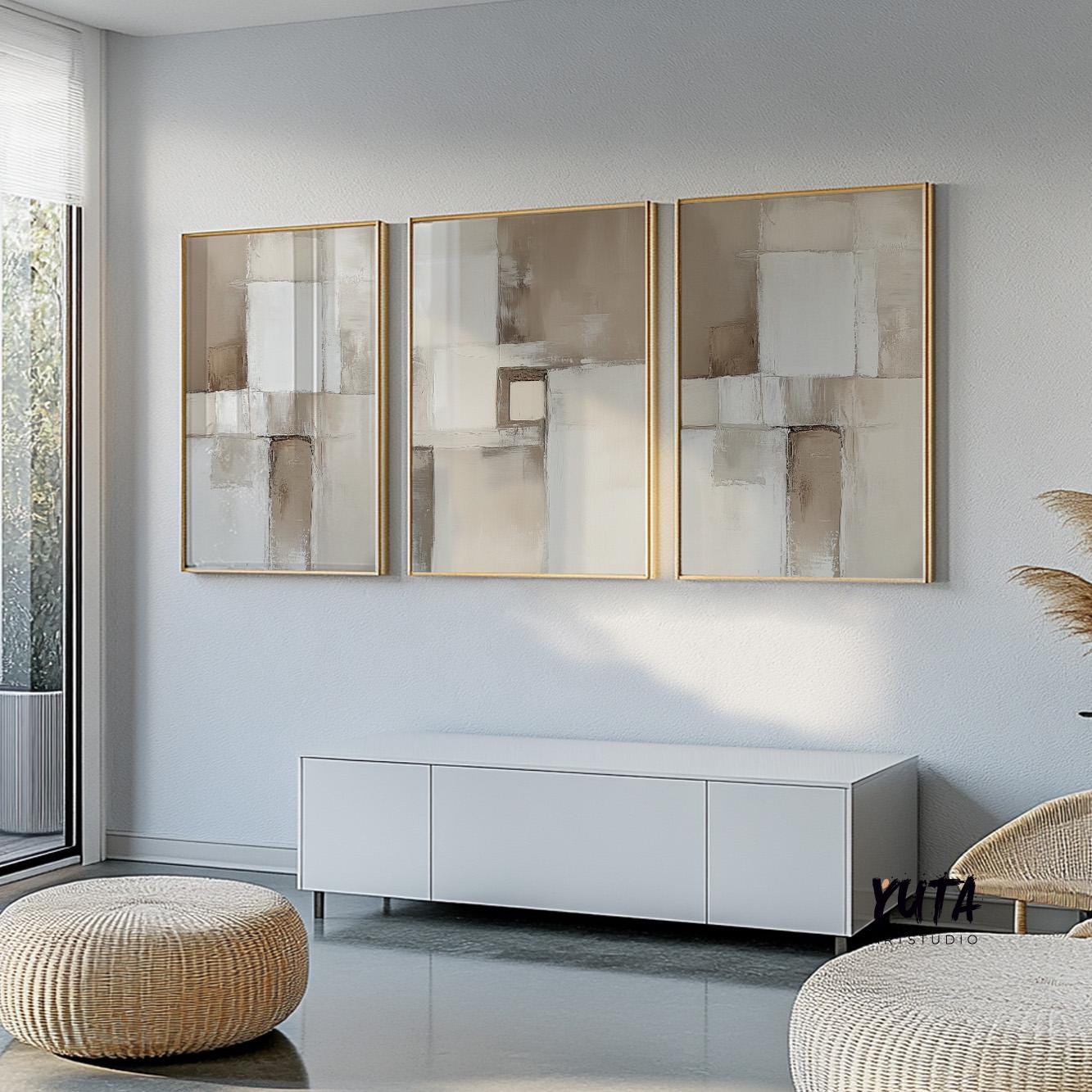 Three neutral abstract brush stroke prints framed and arranged in a modern gallery set