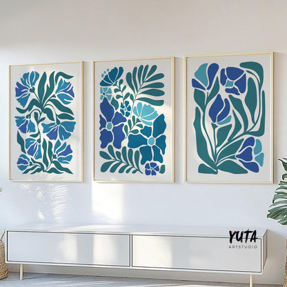 Bold blue botanical prints in a mid century style, framed as a trio above a white console