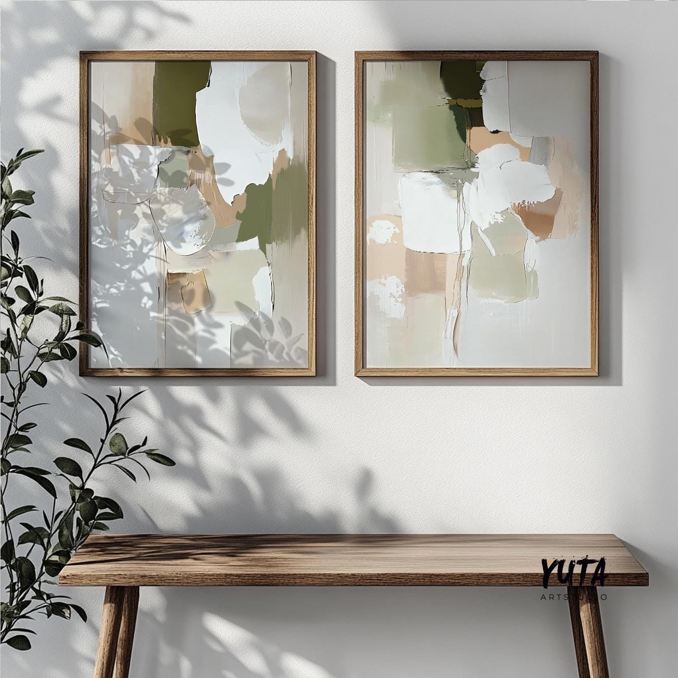 Pair of abstract pastel olive and beige prints in oak frames above a table with plant shadows