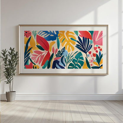 Framed Matisse-style tropical leaves print hanging above a potted plant on a sunlit wall