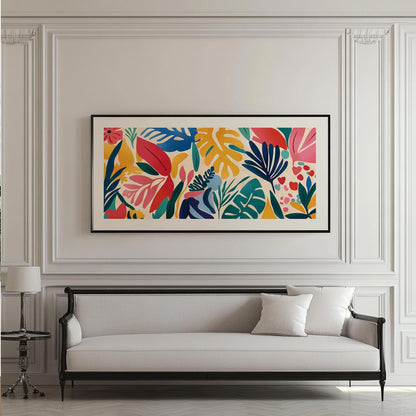 Framed abstract tropical leaf print in vivid colors hung above a classic white sofa.