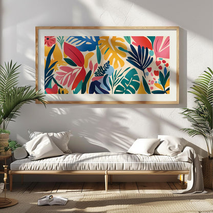 Tropical abstract leaf artwork in a light wood frame displayed above a daybed