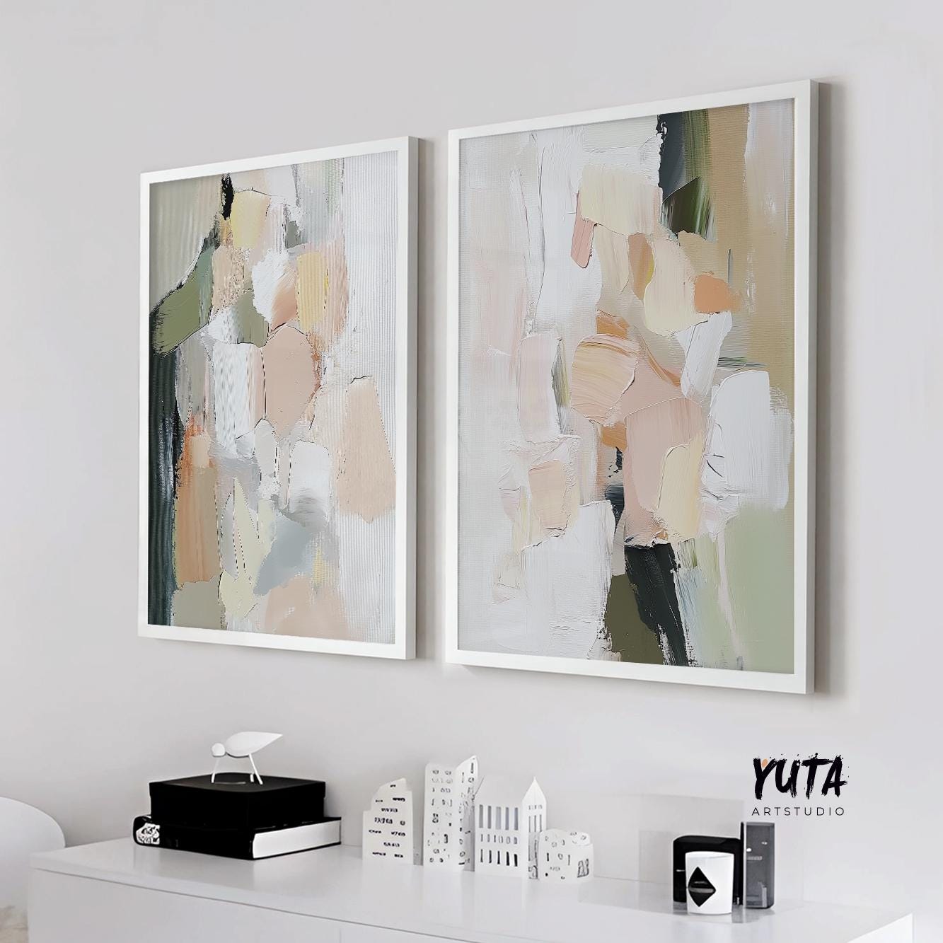 Two framed abstract pastel prints in pink and green above a white console, medium size shown