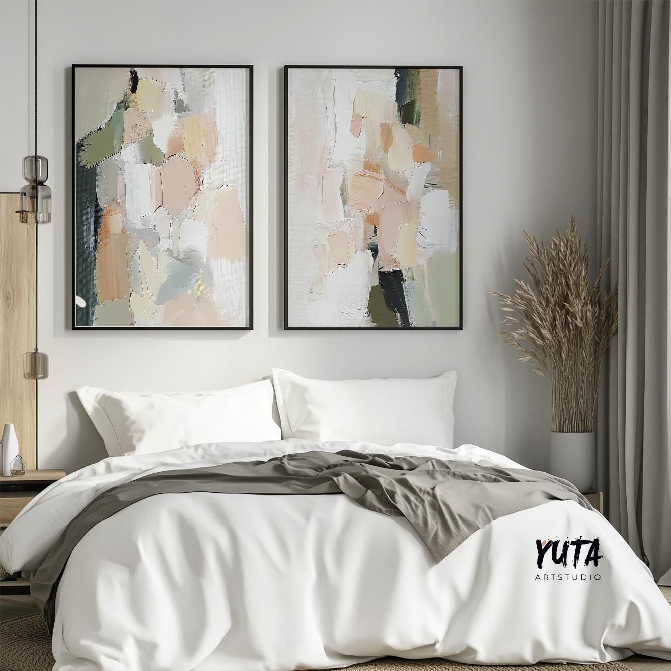 Pair of abstract pastel brushstroke prints in black frames hung above a bed