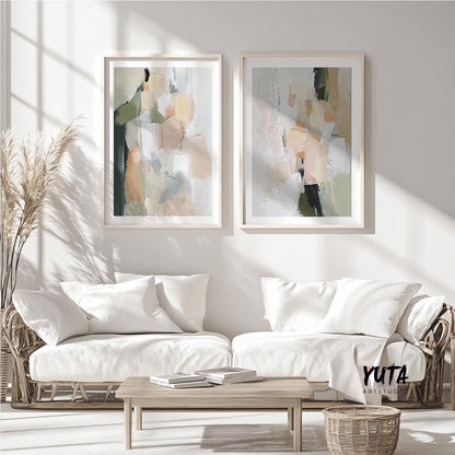 Abstract pastel brush stroke art pair in light wood frames above white sofas