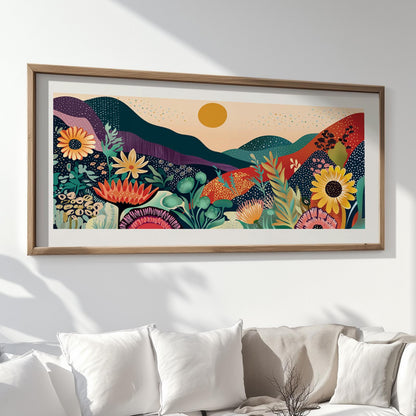 Colorful abstract mountain and floral art in a wood frame displayed above a white couch