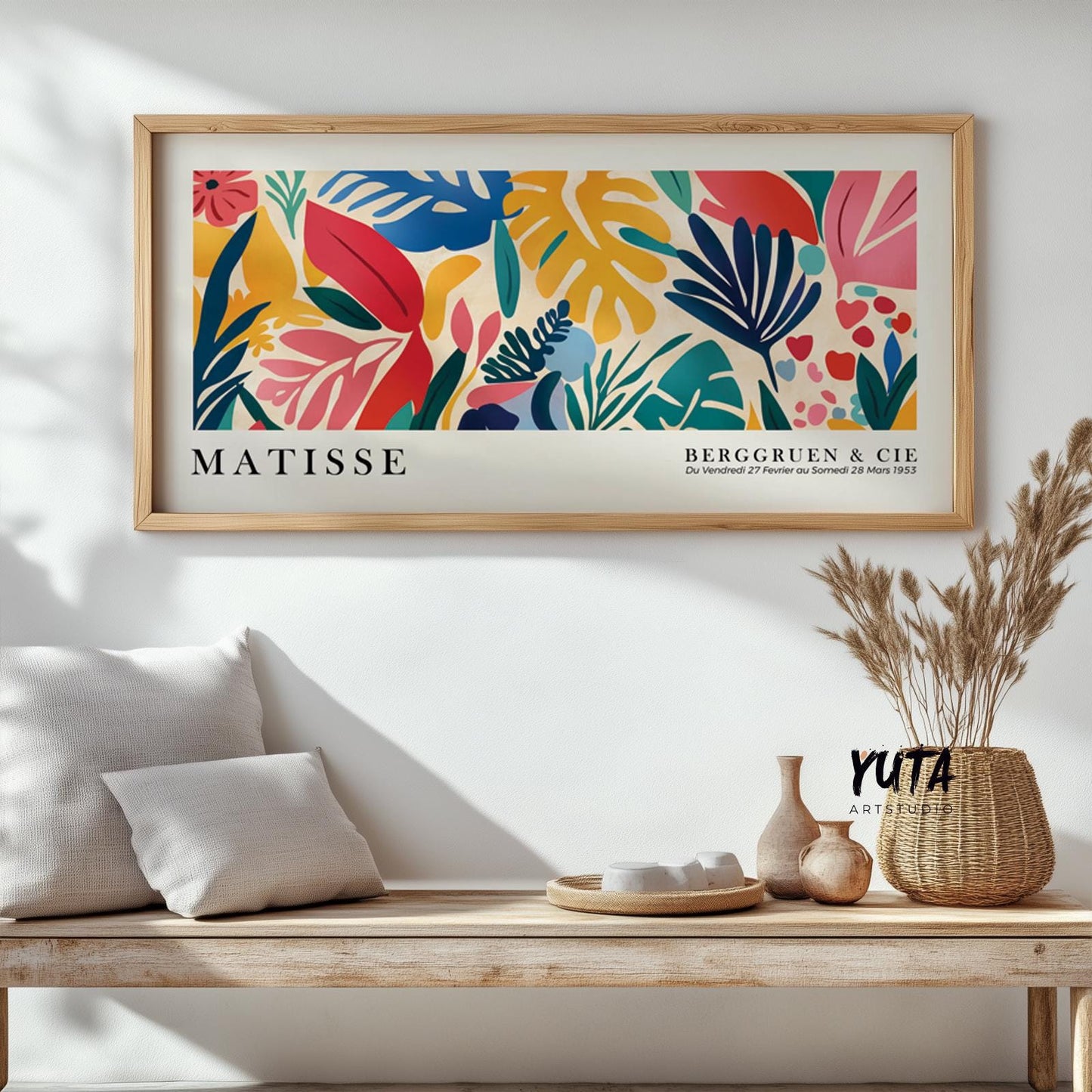 Bold tropical leaves in Matisse cut-out style, framed and displayed above a bench.