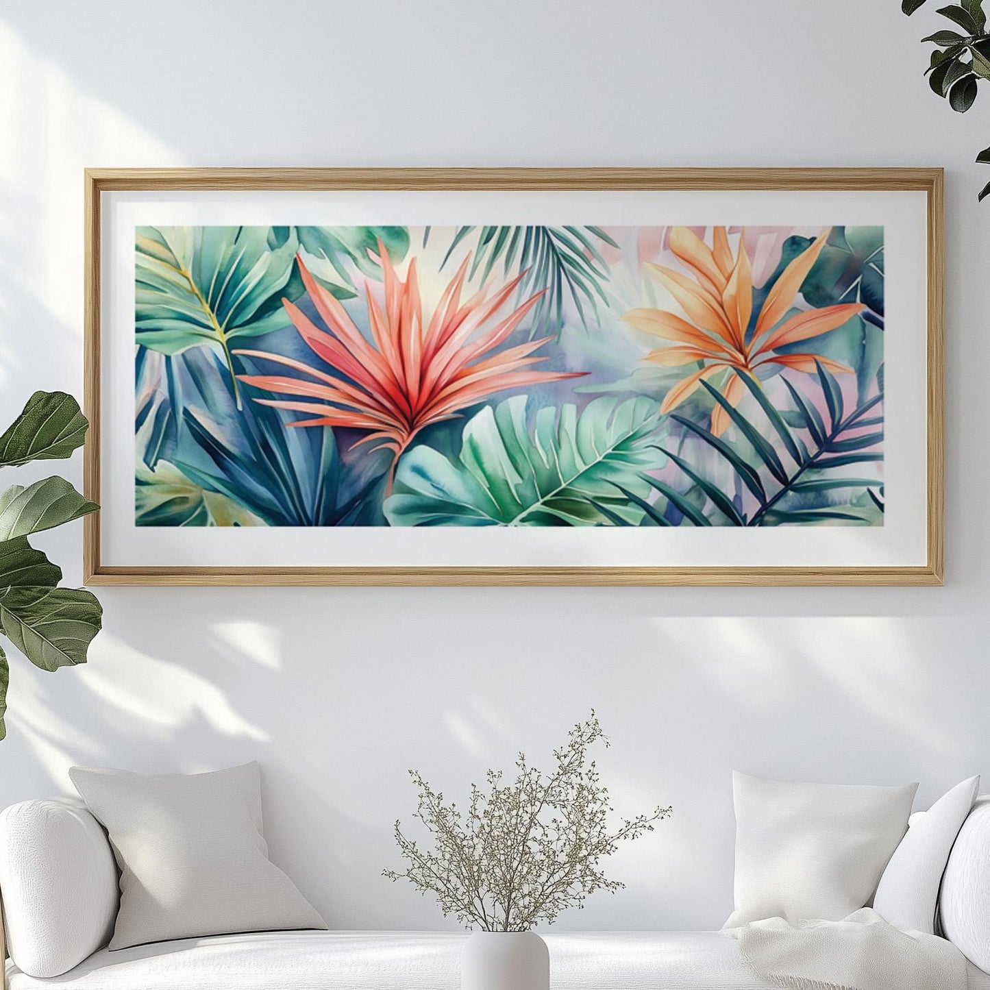 Framed panoramic tropical leaves artwork displayed above a white sofa in natural light