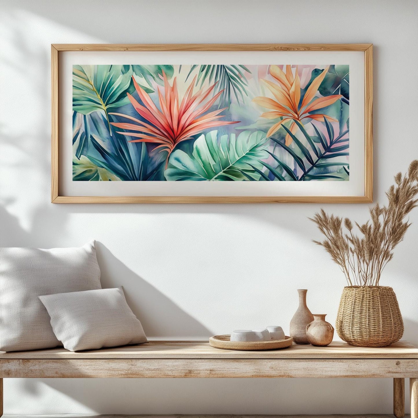 Framed panoramic tropical leaves artwork above a wooden bench with ceramics and books.