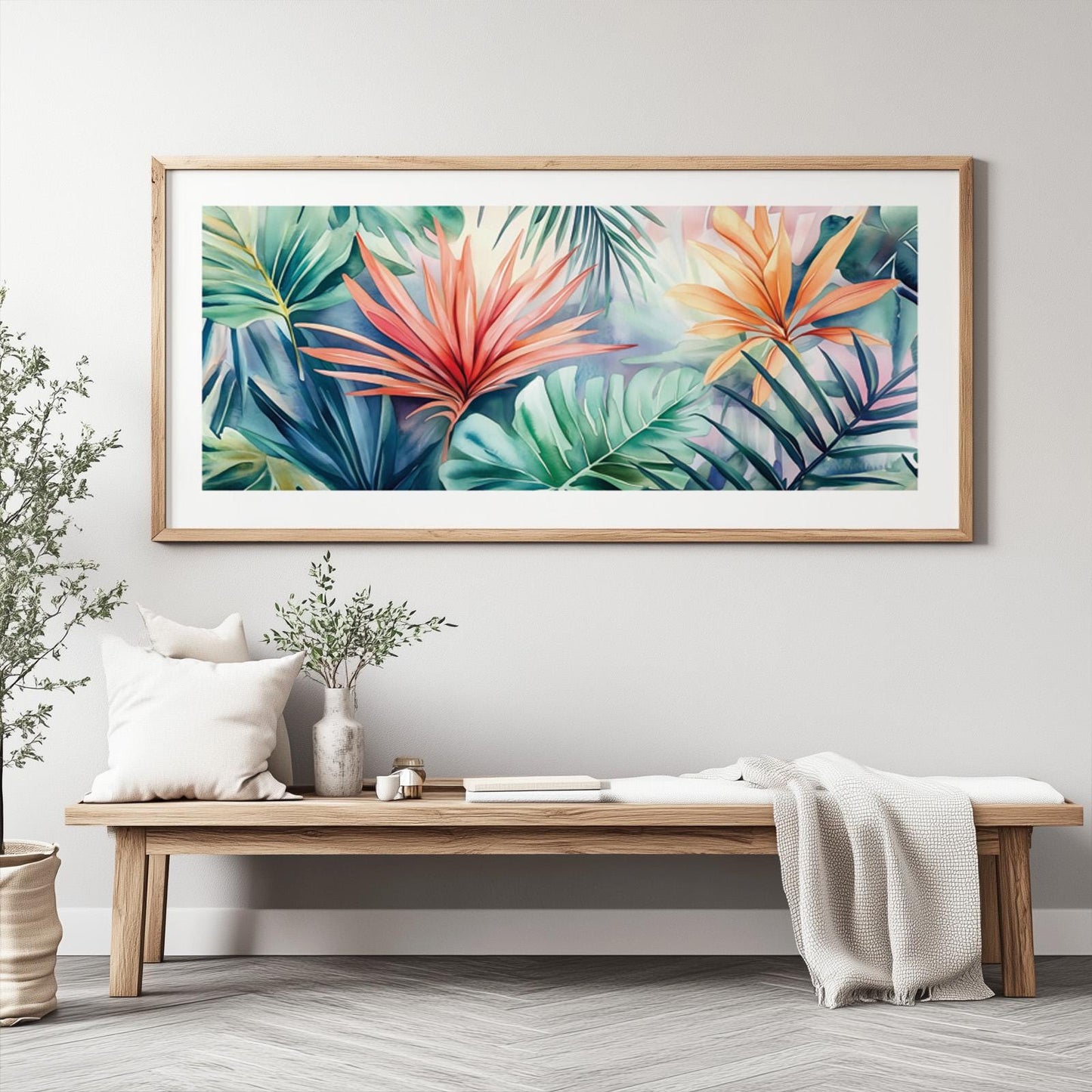 Vibrant tropical leaves painting in a light wood frame above a minimalist console bench