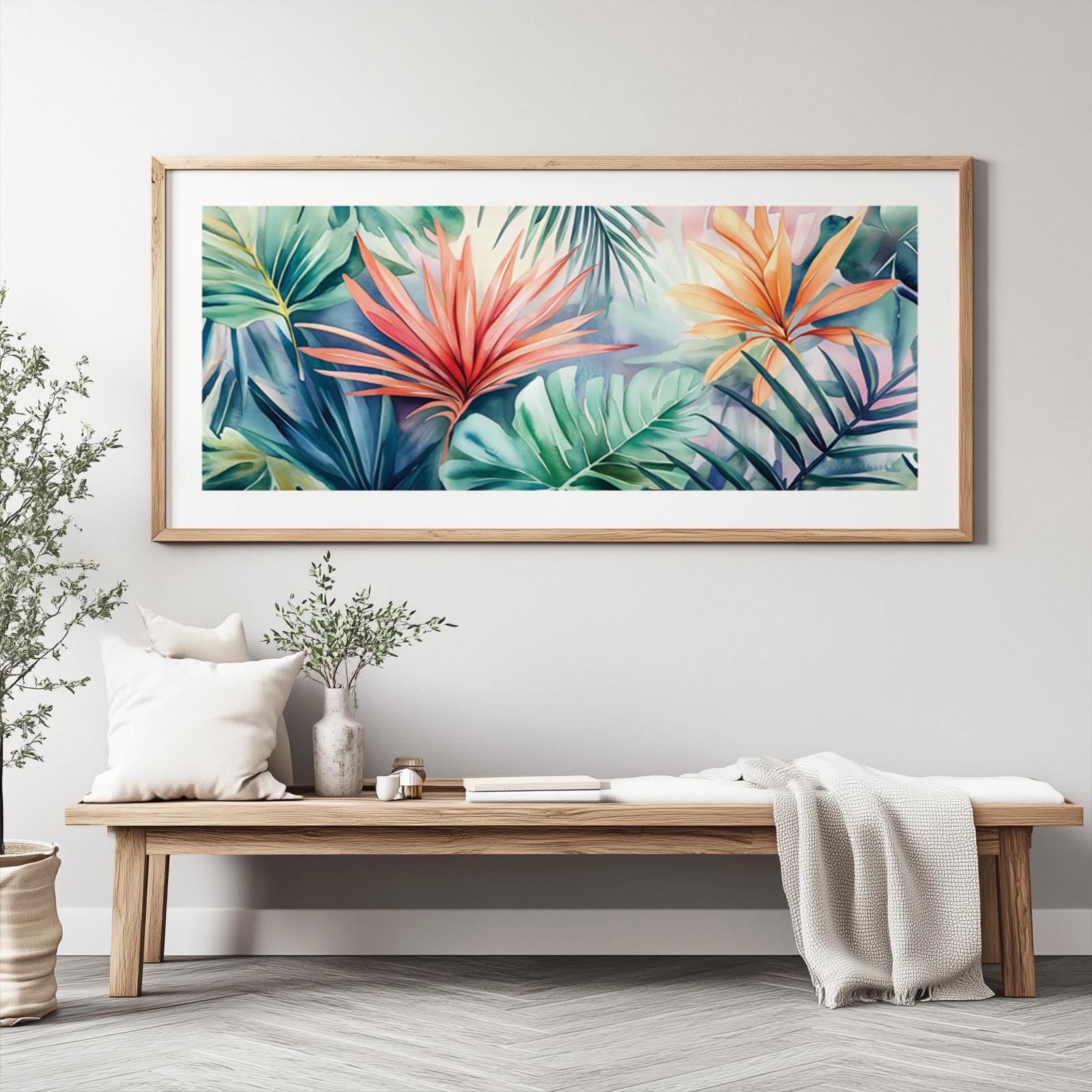 Vibrant tropical leaves painting in a light wood frame above a minimalist console bench