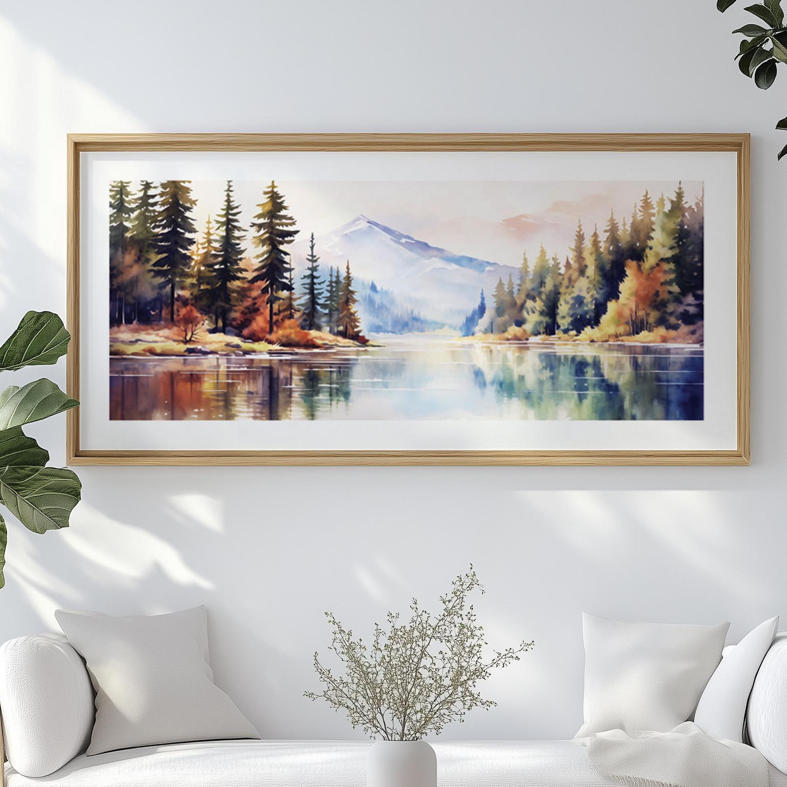 Watercolor mountain landscape artwork in a light wood frame above a white sofa