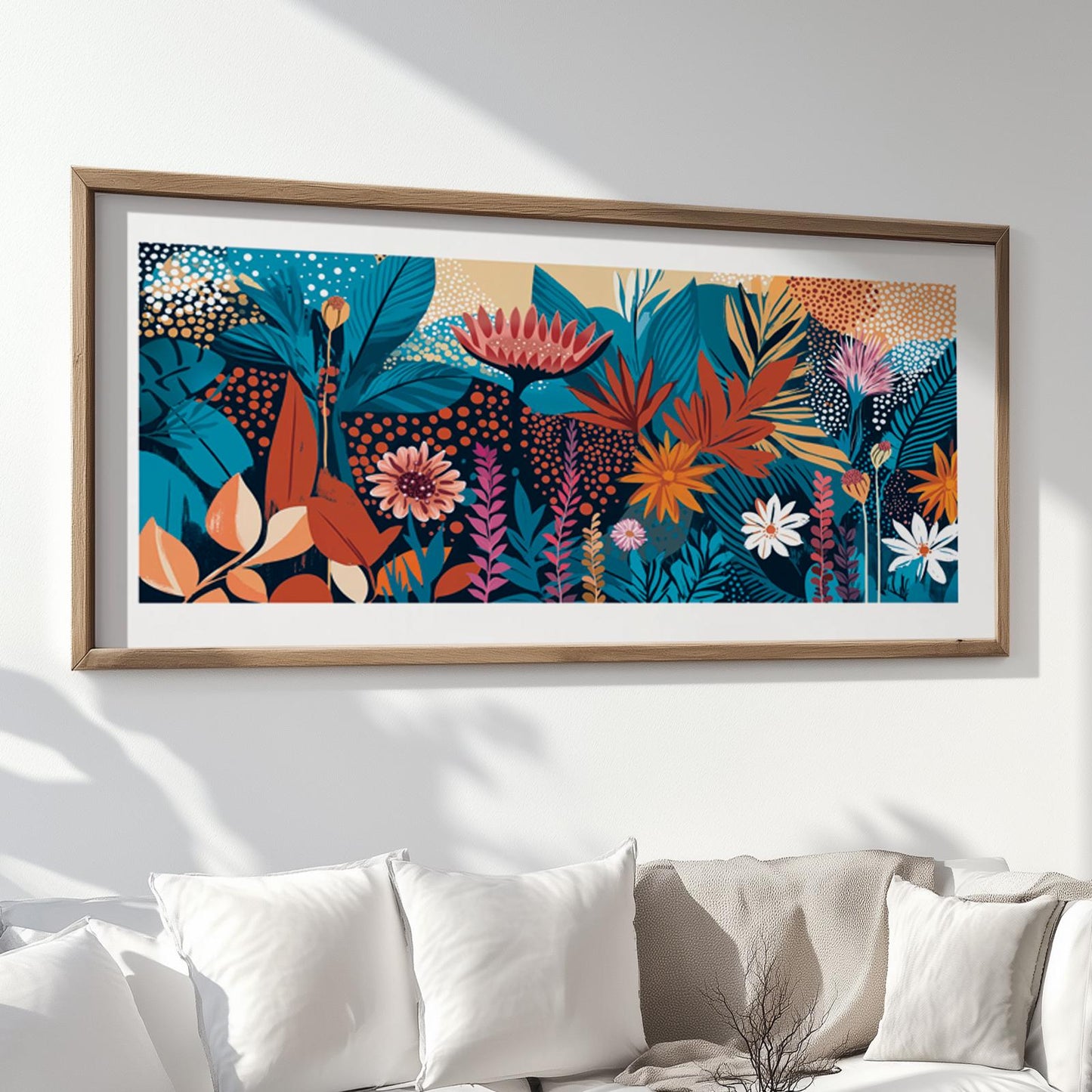 Framed panoramic abstract floral artwork with layered colorful blooms and leaves above sofa