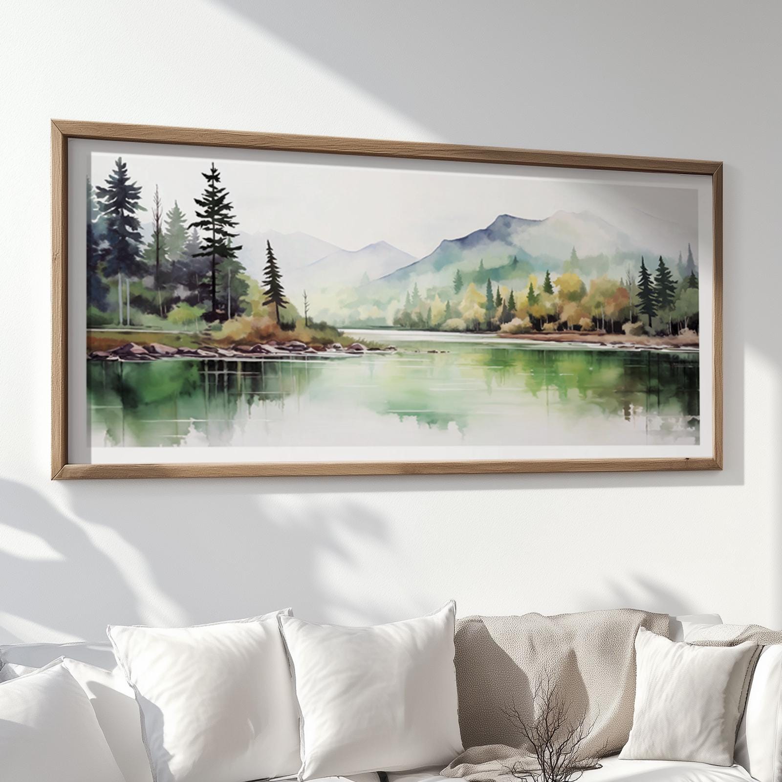 Watercolor mountain landscape print with forest reflections, framed in natural wood