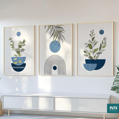 Abstract botanical wall art trio in gold frames arranged above a white console