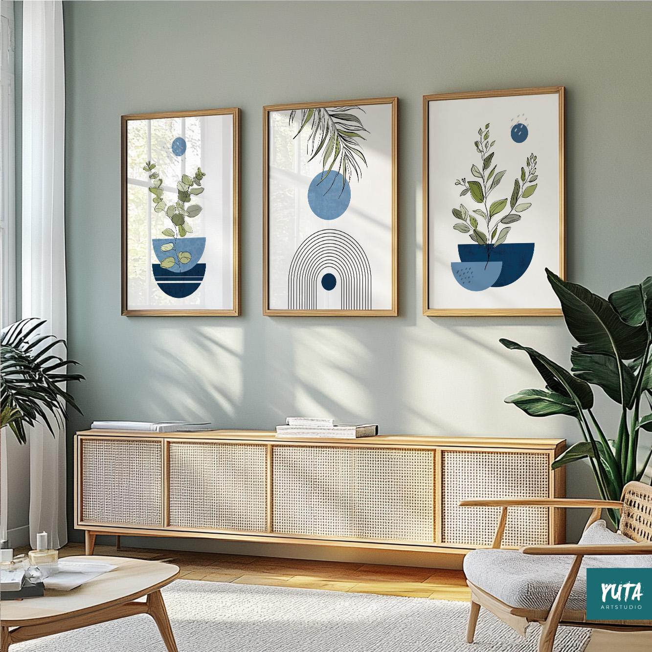 Three framed navy and blue abstract botanical prints displayed above a light wood sideboard