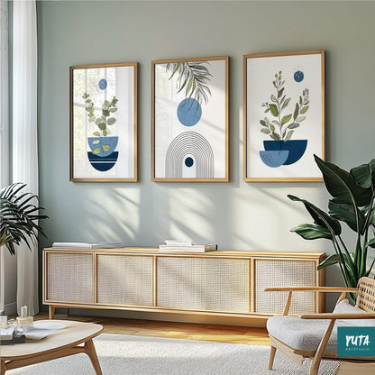 Three framed navy and blue abstract botanical prints displayed above a light wood sideboard
