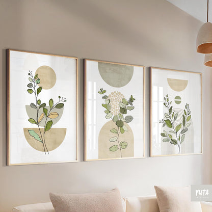 Trio of framed sage green botanical prints displayed together above a cream sofa.