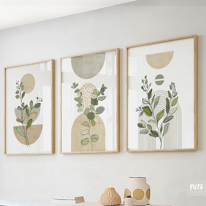 Trio of sage green abstract botanical prints in wooden frames above ceramics and books