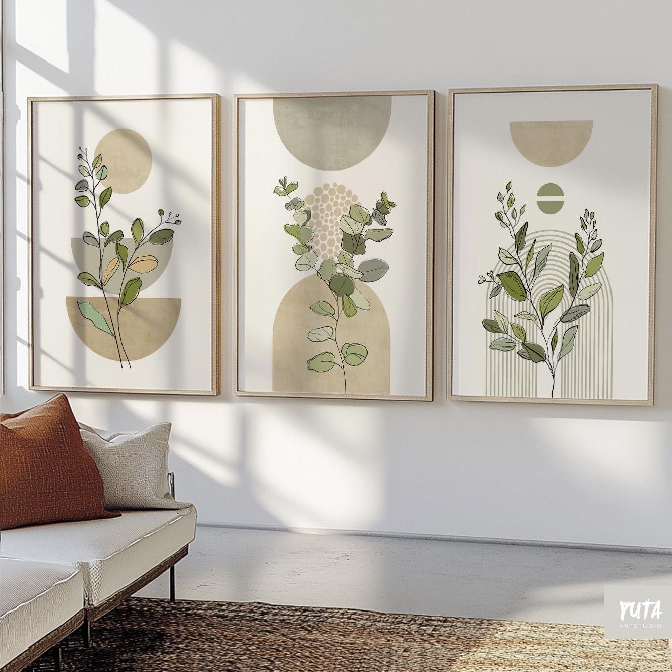 Set of three framed sage green botanical prints in boho mid-century style above a console.