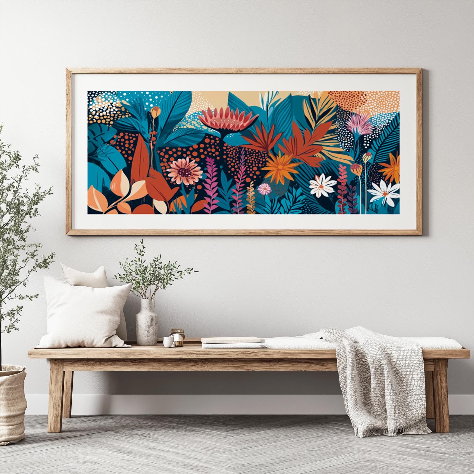 Vivid abstract floral artwork in a light wood frame displayed above a minimalist bench
