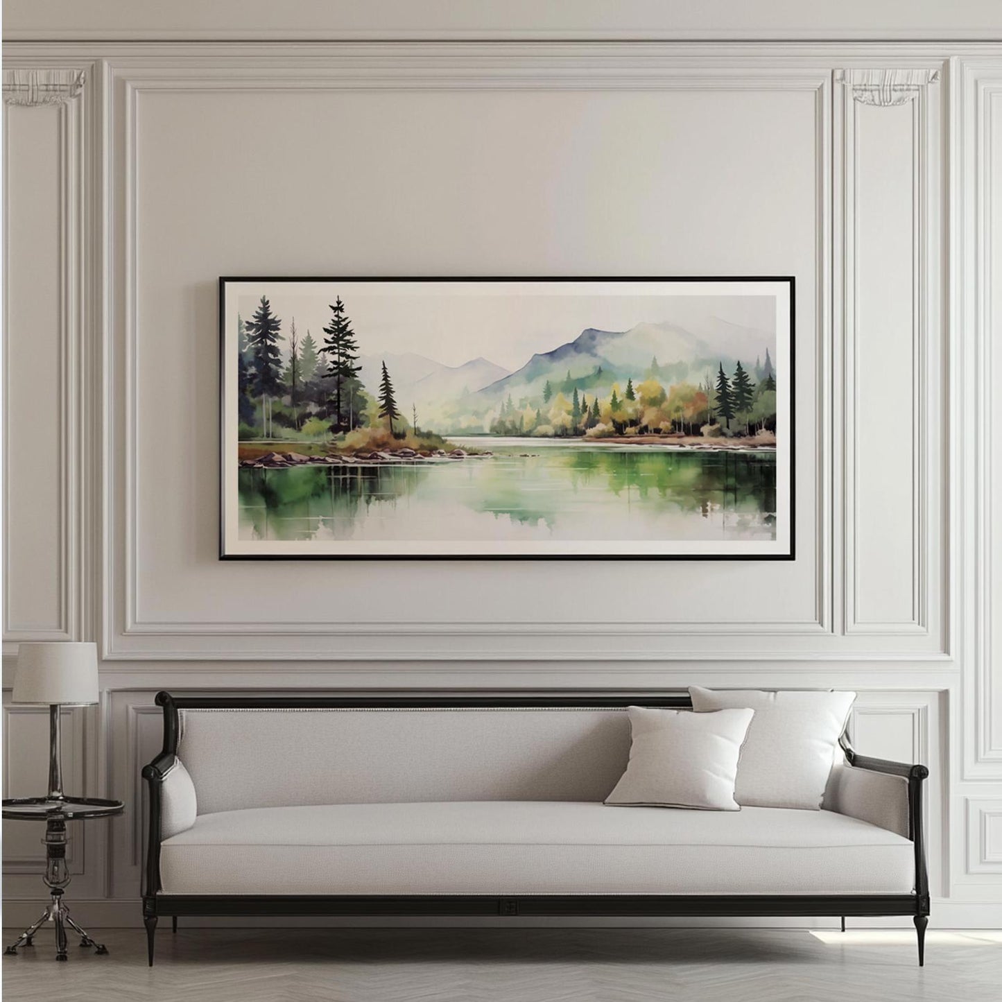 Framed watercolor forest landscape artwork displayed above a white upholstered sofa