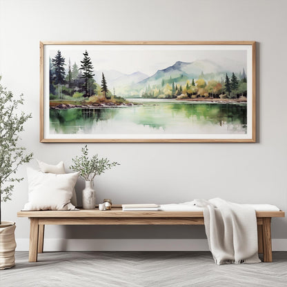 Framed watercolor forest and mountain landscape hung above a wooden bench with neutral decor