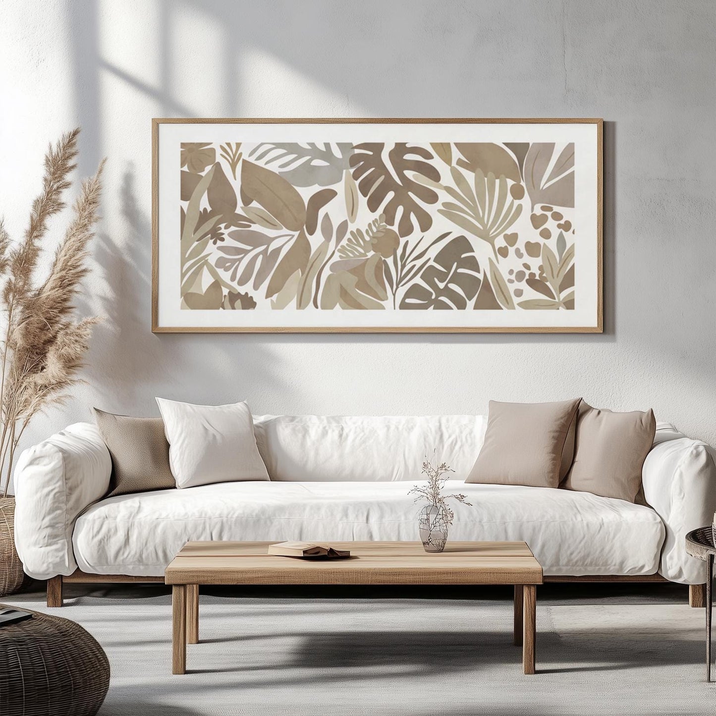 Mocha-toned framed tropical botanical print hung above a white sofa as size reference