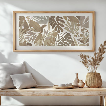 Abstract tropical leaf print in neutral tones, framed above a wooden bench with cushions