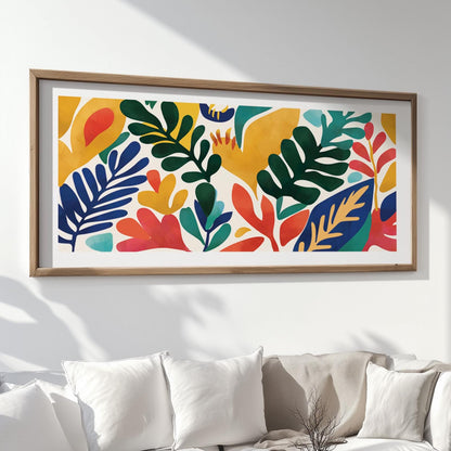 Colorful abstract leaf artwork in a natural wood frame hung above a white sofa