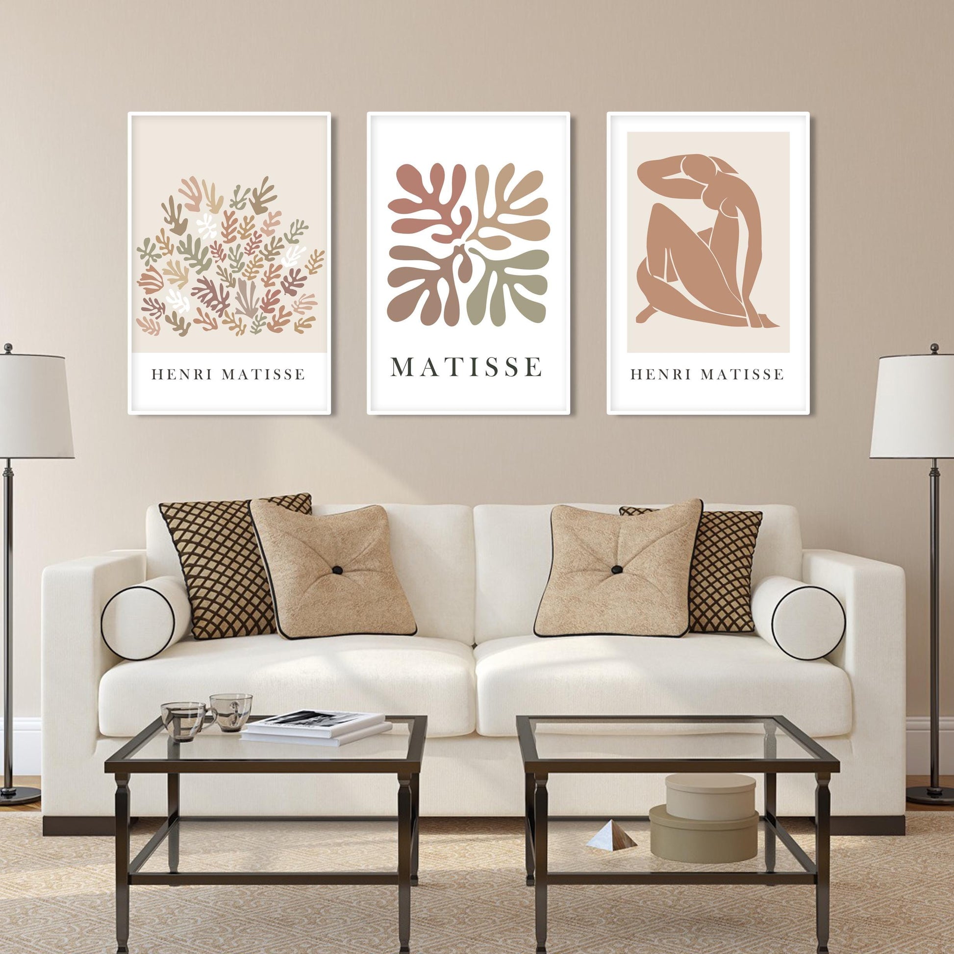 Abstract Matisse-inspired art trio in white frames showcased above a glass console.