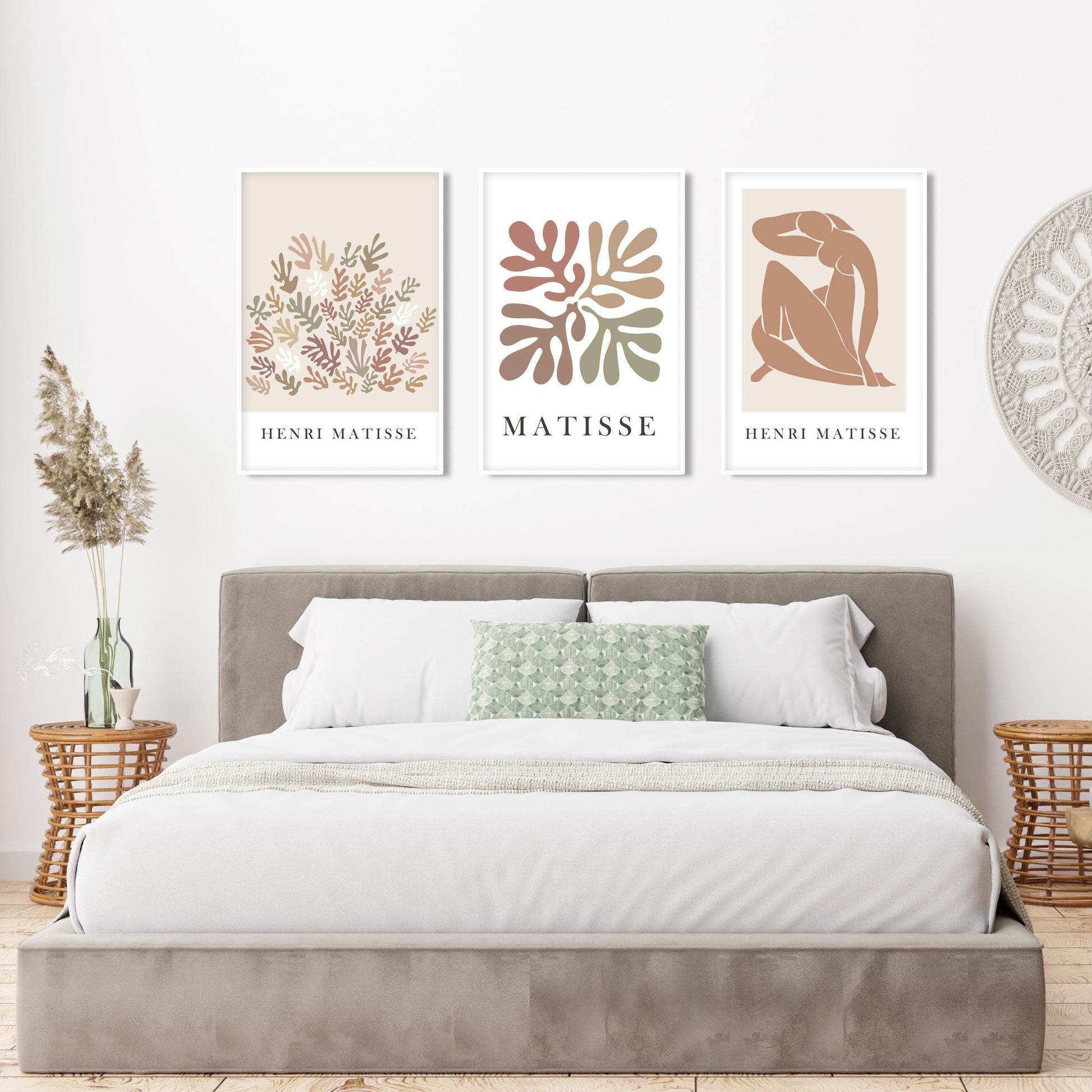 Neutral Matisse art trio in white frames displayed above a taupe velvet bed