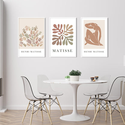 Abstract Matisse-inspired prints in beige tones, framed as a three-piece art set above a dining table.