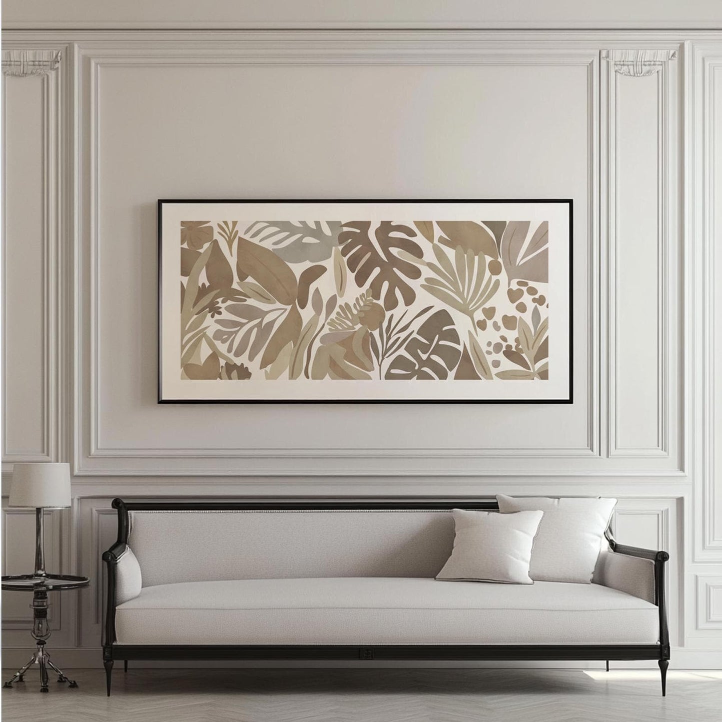 Abstract tropical leaf artwork in muted beige tones, framed in black and centered on a paneled wall