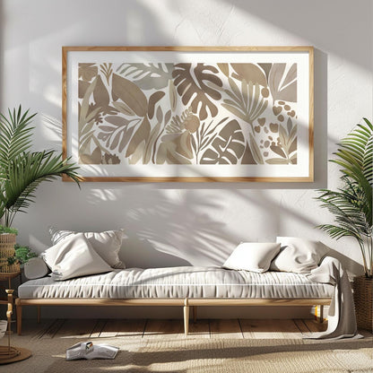 Framed neutral botanical print with abstract tropical leaves bathed in sunlight above a daybed