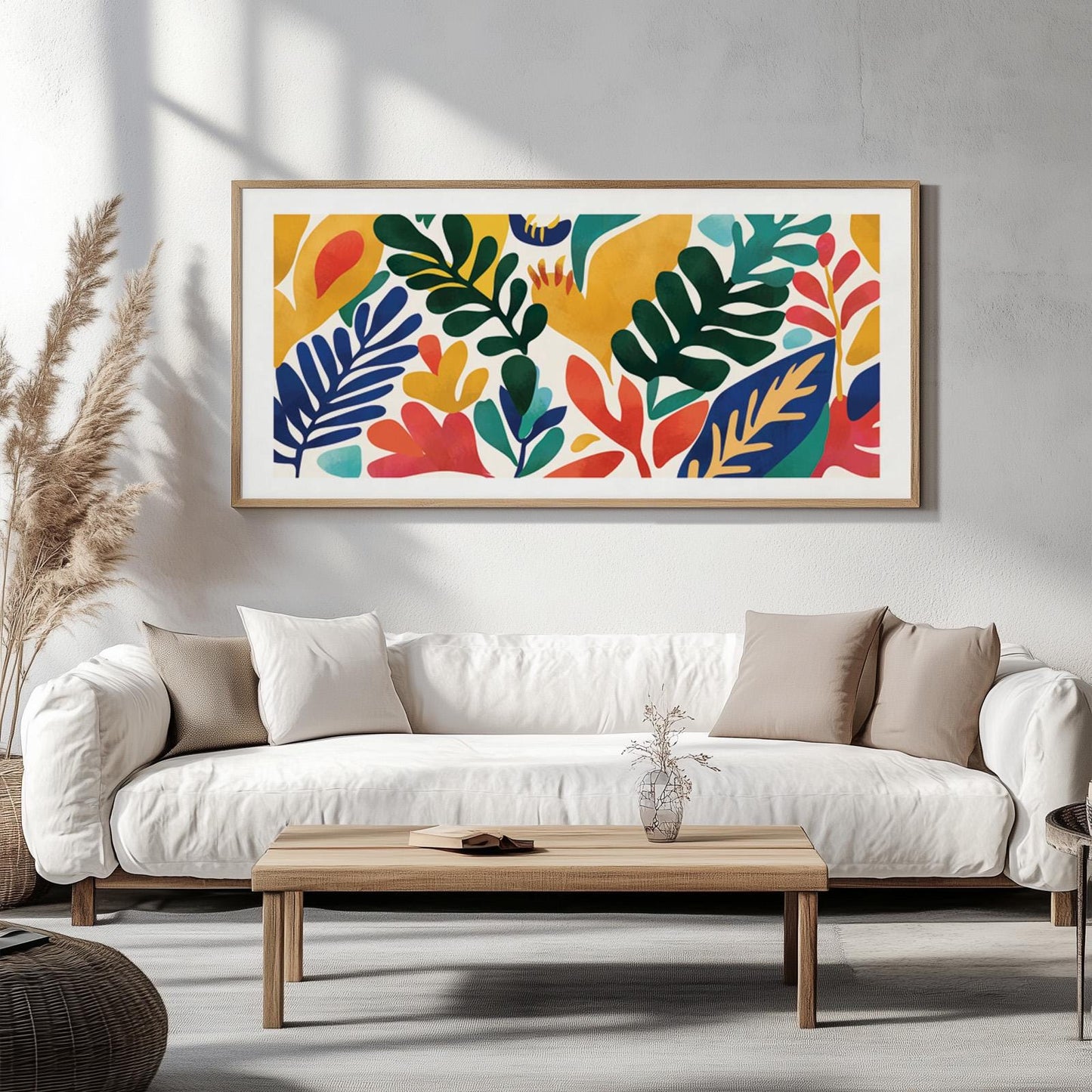 Colorful botanical wall art with abstract leaves in a light wood frame above a white sofa