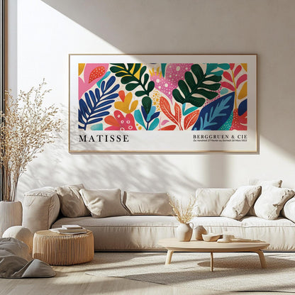 Colorful leaf abstract in modern wood frame, centered above a neutral sofa setup