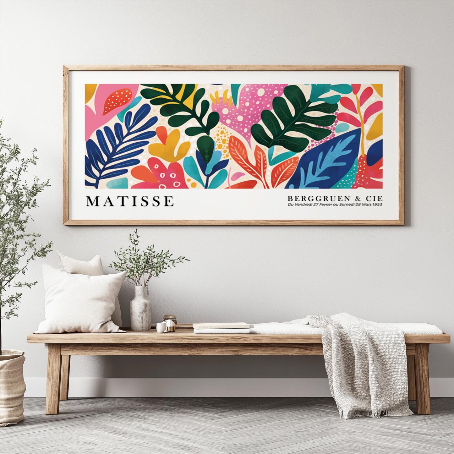 Vivid tropical foliage artwork in Matisse style, framed and hung above a wood bench.