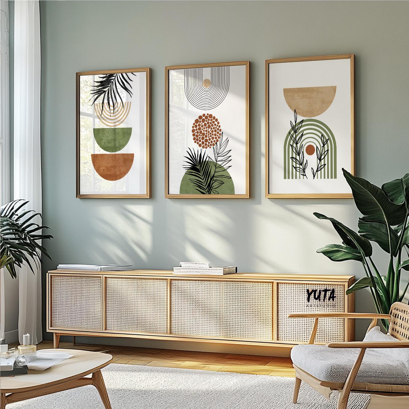Boho abstract leaf and arch art trio in light wood frames above a modern sofa