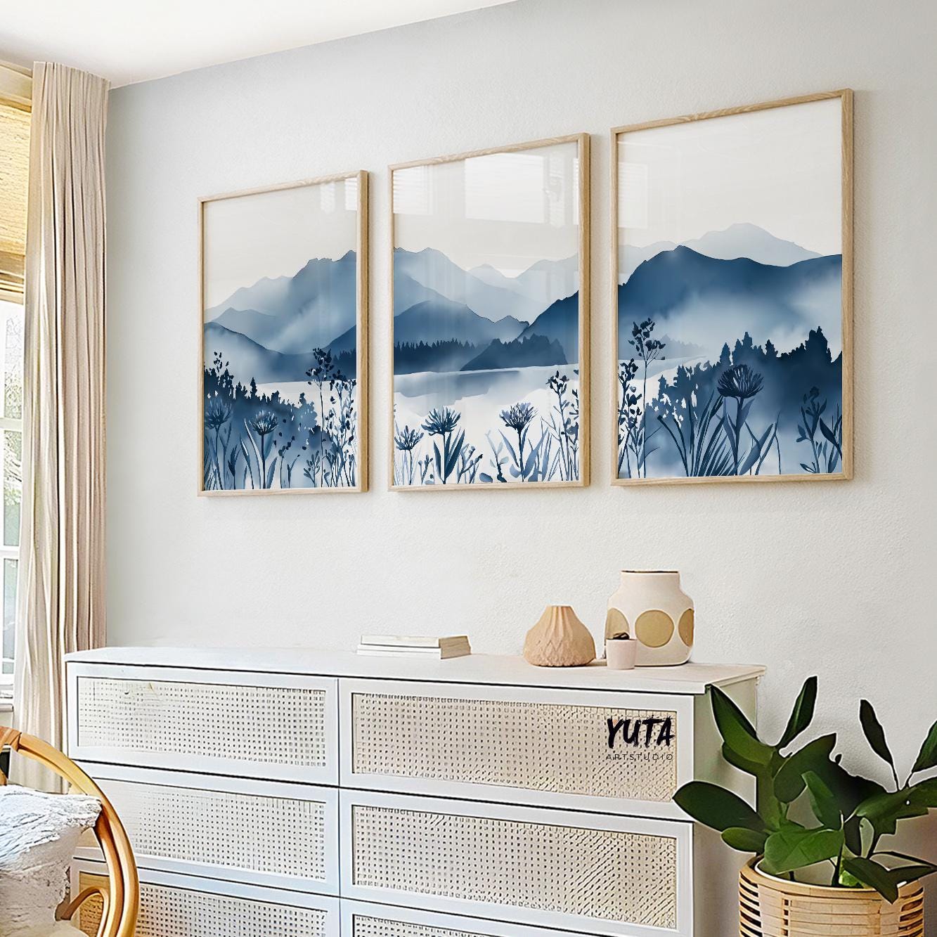 Minimalist triptych wall art featuring misty blue mountains and floral silhouettes, calming decor for living room or hallway