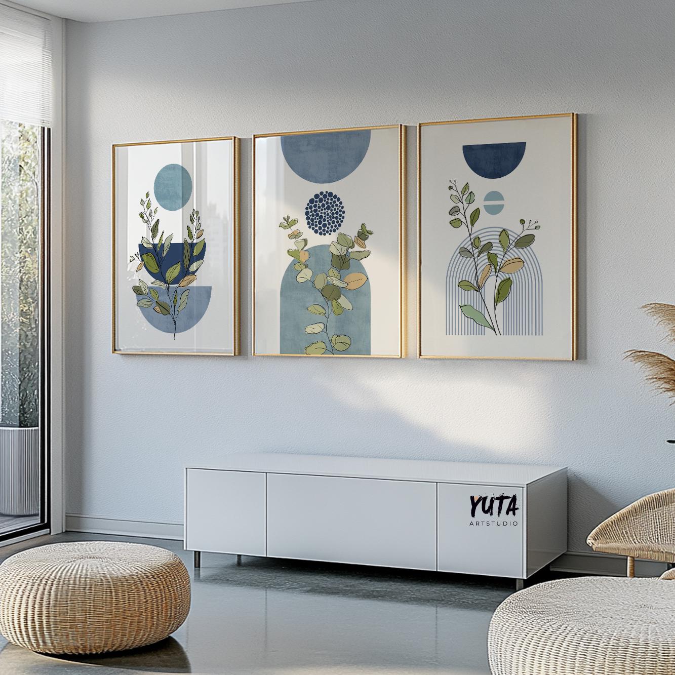 Botanical geometric artwork in blue and gold frames, three-piece gallery above white console