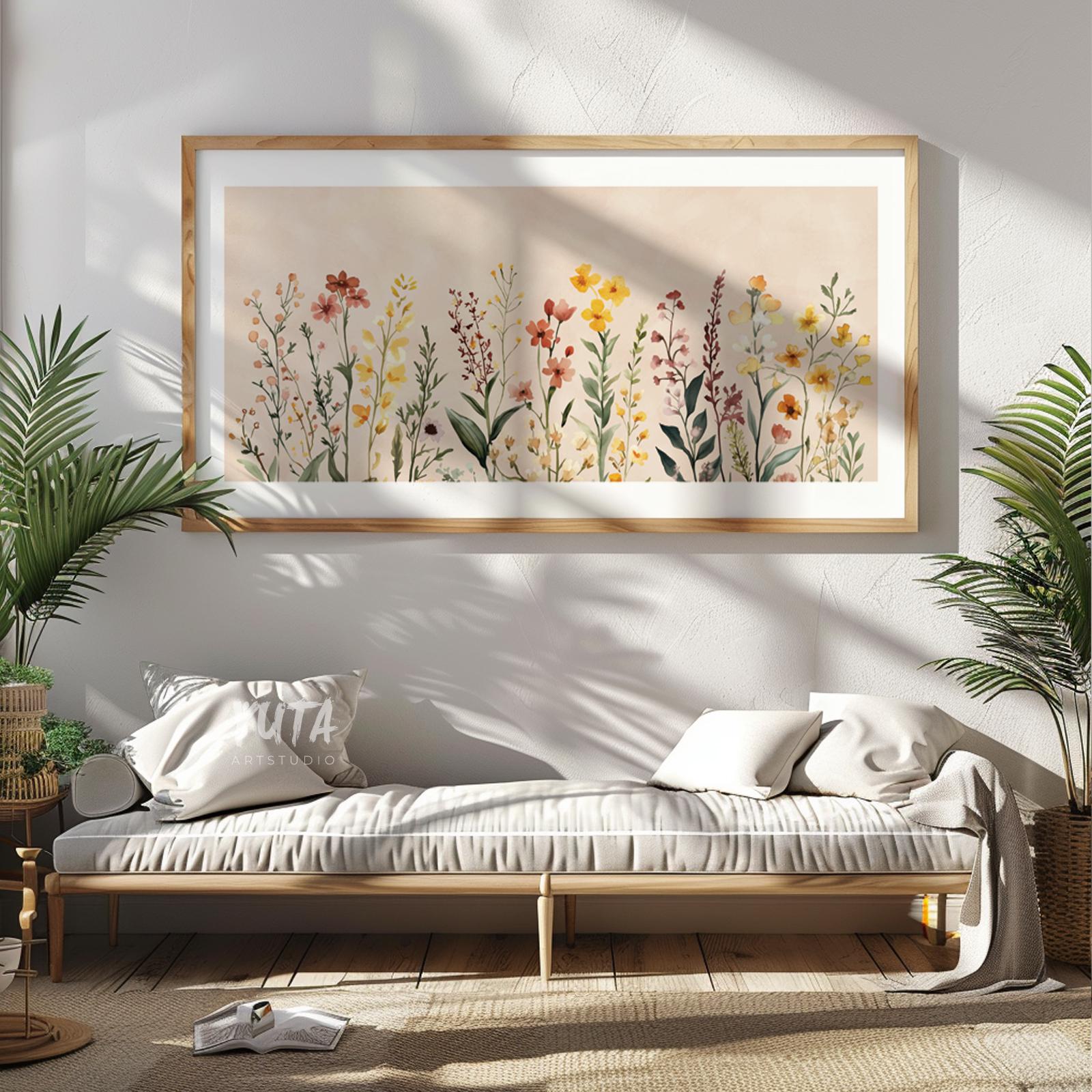 Framed neutral floral artwork featuring watercolor wildflowers, displayed above a bench in soft daylight