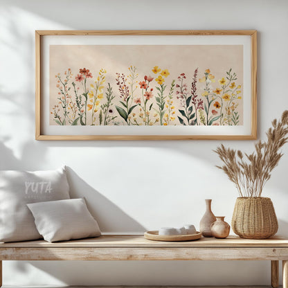 Neutral floral artwork in a light wood frame centered above a wooden bench and decor