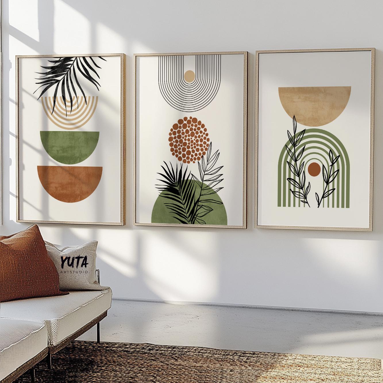 Trio of framed earthy boho botanical prints above a console in sunlit room