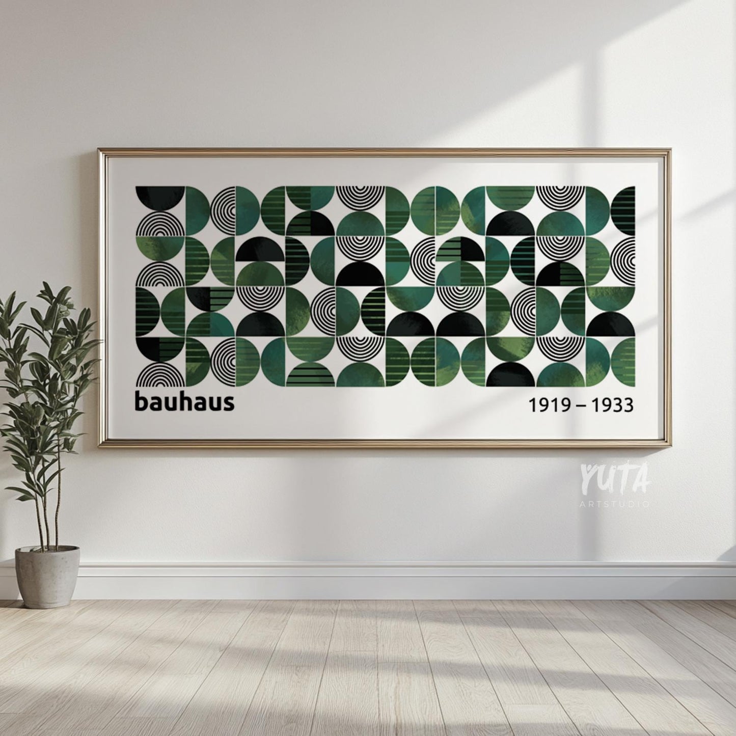 Framed geometric Bauhaus print in green and black displayed above a light wood floor