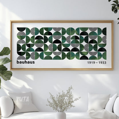 Geometric Bauhaus-style artwork in an oak frame displayed above a white sofa.