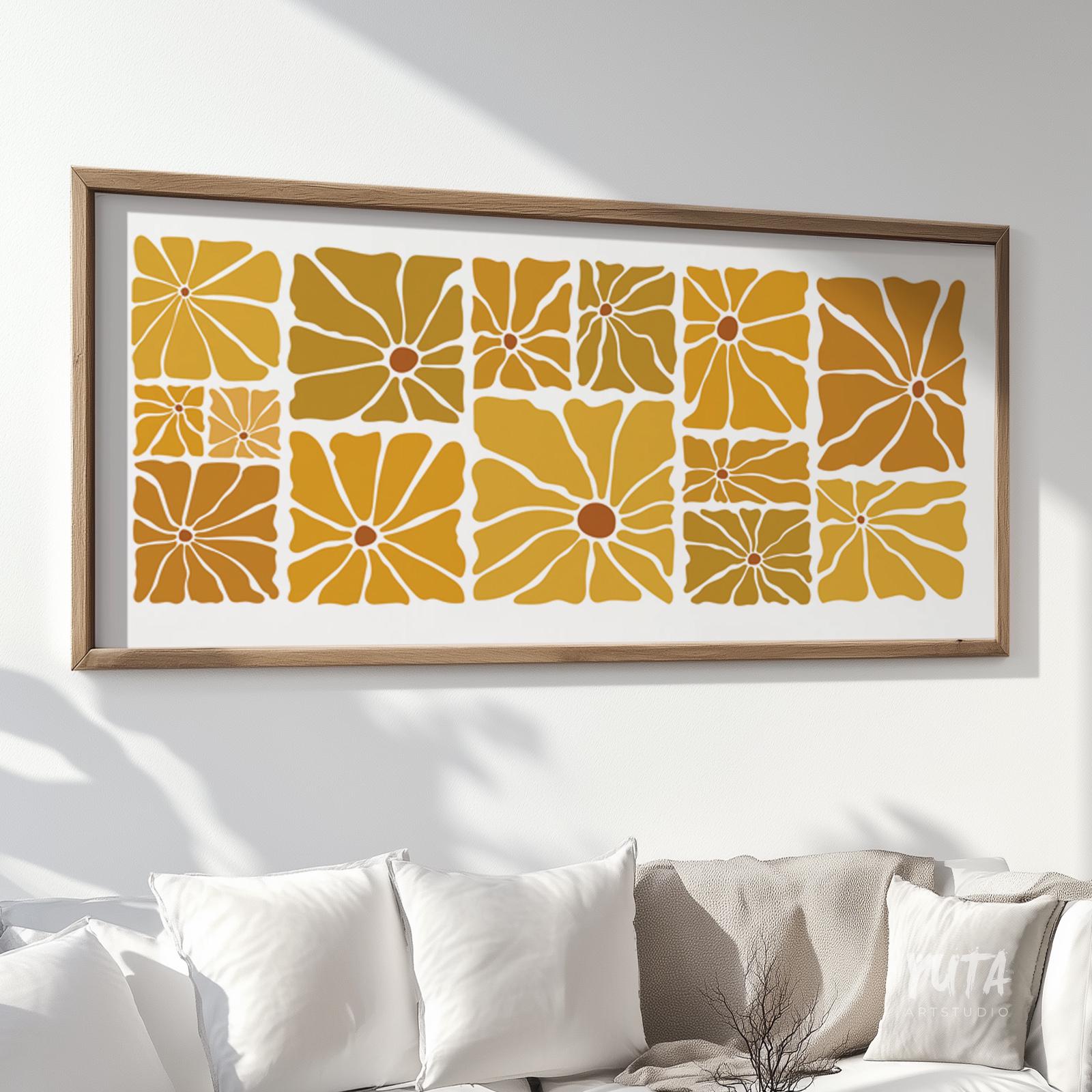 Framed retro floral print in mustard tones shown in large horizontal size above a white sofa