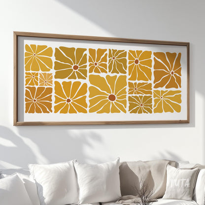 Framed retro floral print in mustard tones shown in large horizontal size above a white sofa