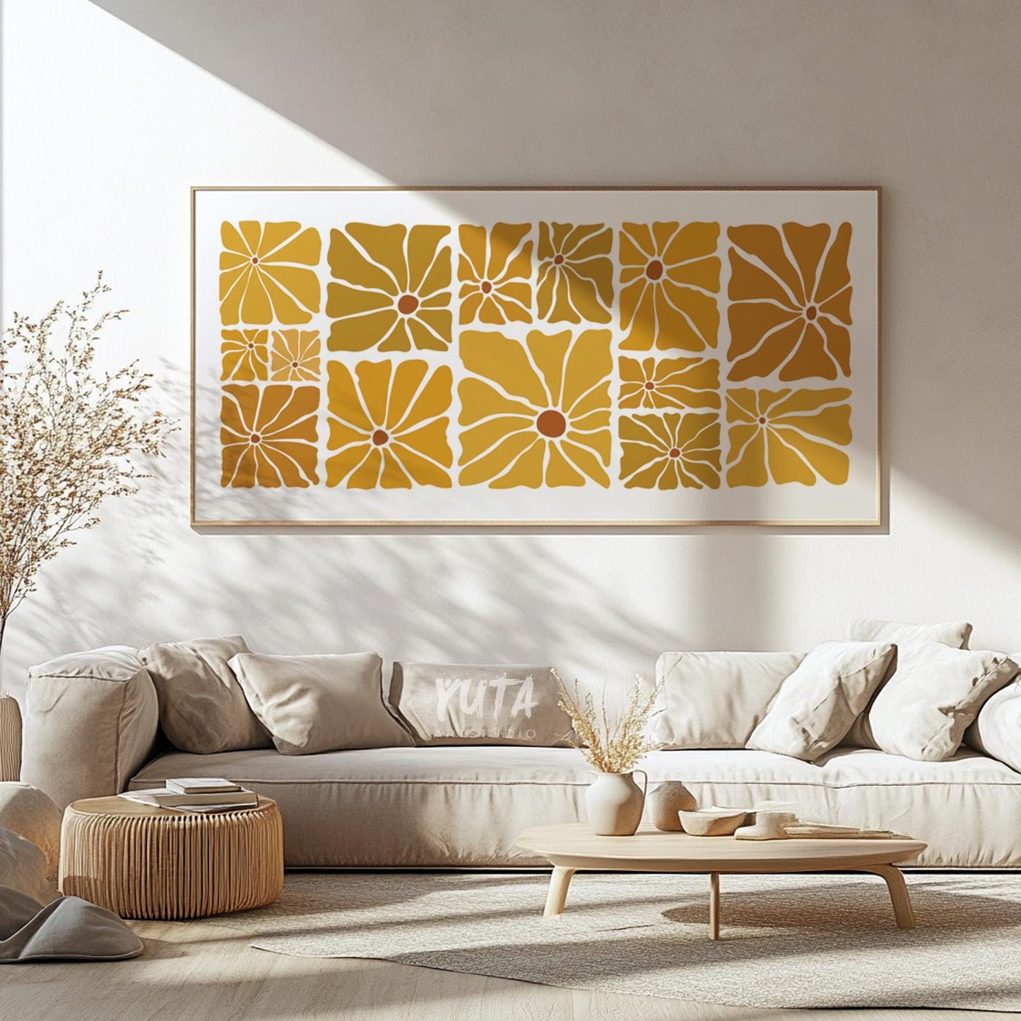 Mustard and ochre abstract floral print in a light wood frame above a cream sofa